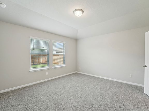 Unwind at the end of the day in the primary bedroom.