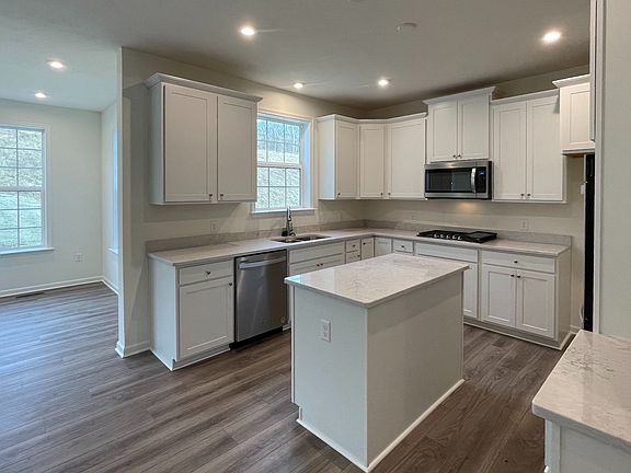 Kitchen and adjoining morning room in a DRB Homes Bristol II Plan at the Villas of South Park commu
