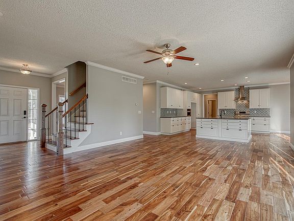 Open living room and kitchen with hardwood floors.