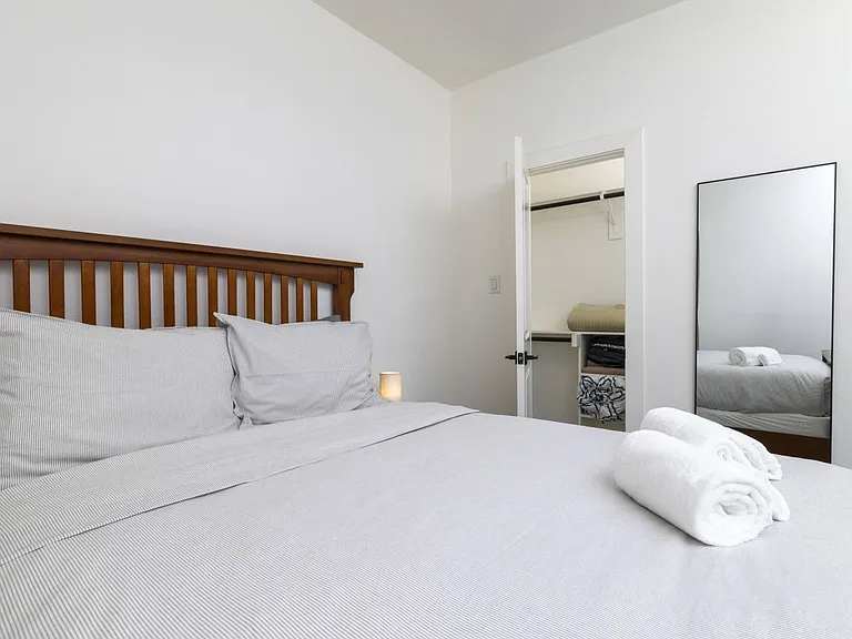 Second bedroom featuring queen bed and attached closet.