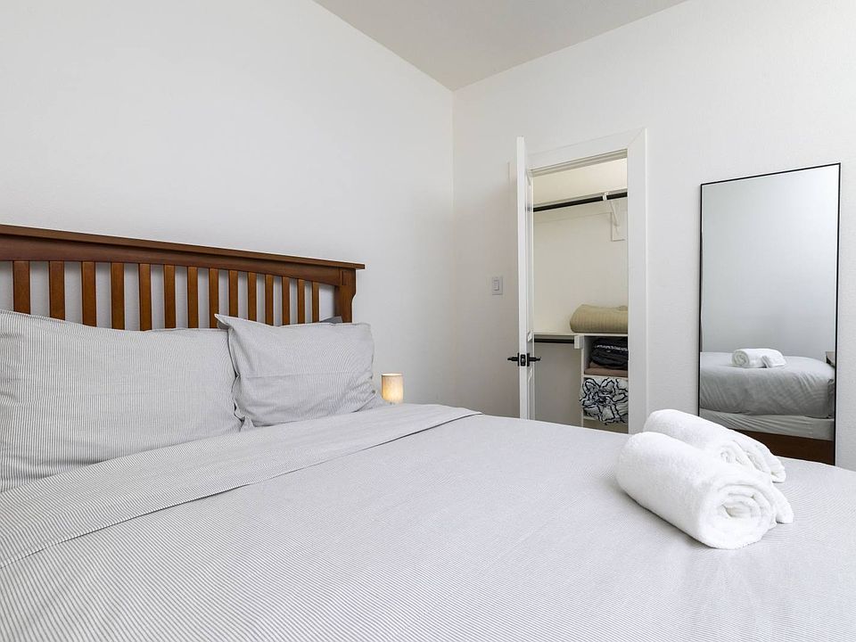 Second bedroom featuring queen bed and attached closet.