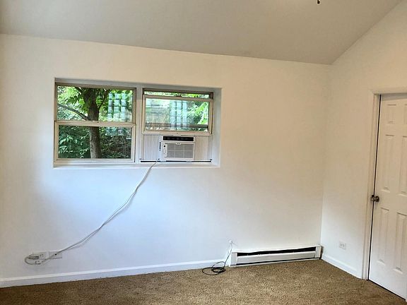 Main Living Space with vaulted Ceilings and Window A/c Unit