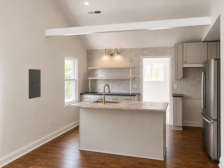 Brand new kitchen cabinets, quartzite island, honed granite perimeter, all new appliances and fixtures. *Construction clutter has been removed from image using AI.