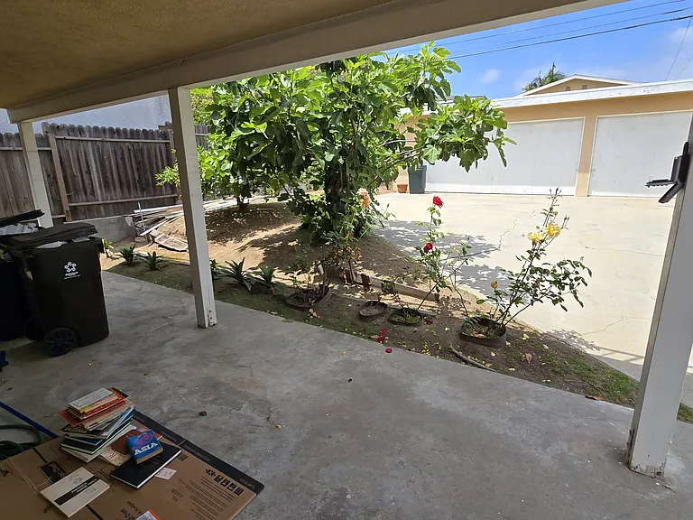 Rear covered patio facing 3-car garage