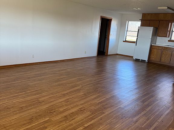 Living room with open kitchen and dining area.