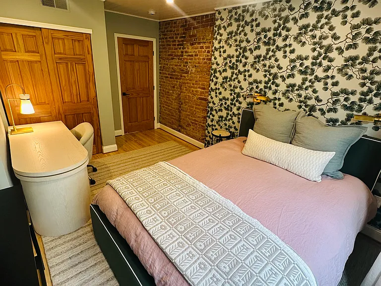 Back bedroom with closet and workspace