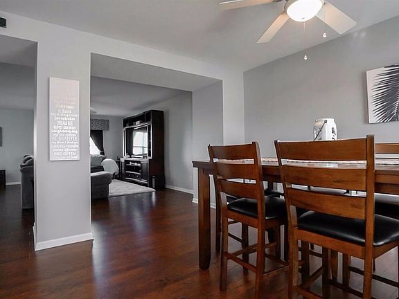 WELCOMED BY FORMAL DINING ROM, PROFESSIONALLY PAINTED, & WOOD FLOORING!