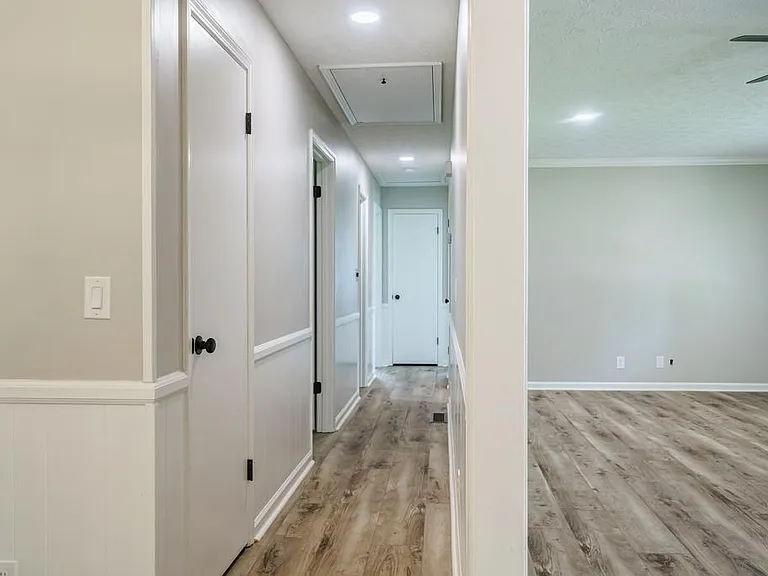 View from Kitchen/Dining Area into bedrooms to the left, down the hall and living room to the right