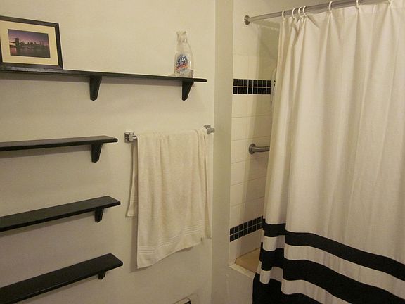 This is a very large bathroom with a separate space for toliet