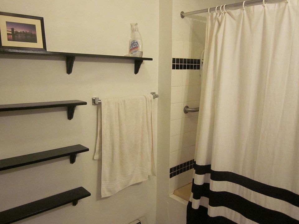 This is a very large bathroom with a separate space for toliet