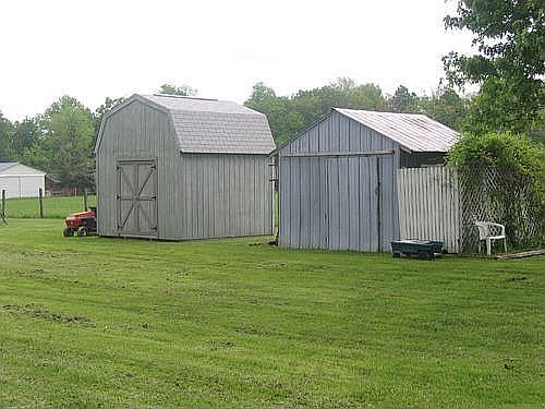 12x12 metal equipment shed and a Barn setup as a wood shop which is insulated,