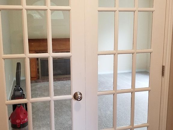French doors that lead into parlor room with oversized closet on right.