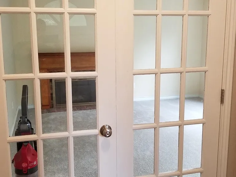 French doors that lead into parlor room with oversized closet on right.