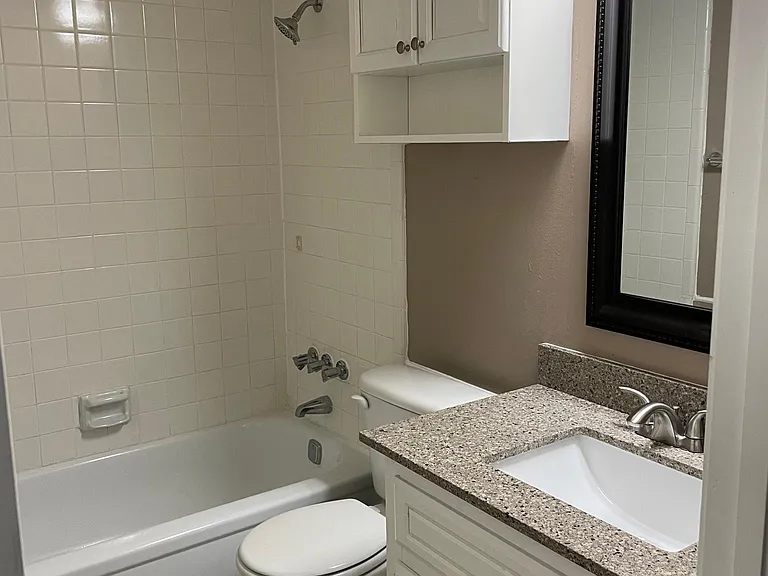 hall bathroom with quartz vanity countertop.