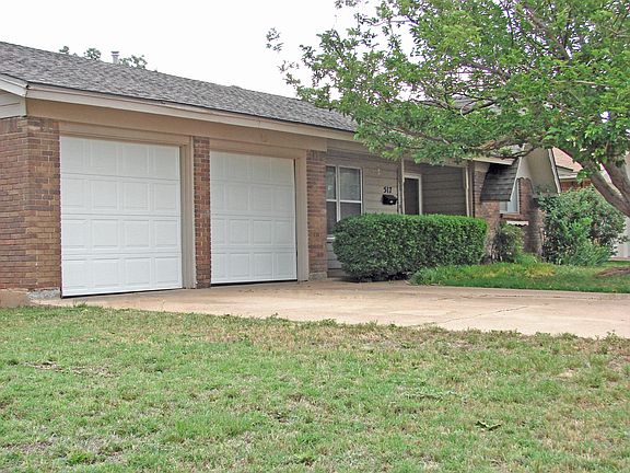 Front of house with new (2013) insulated garage doors viewed from the north-west