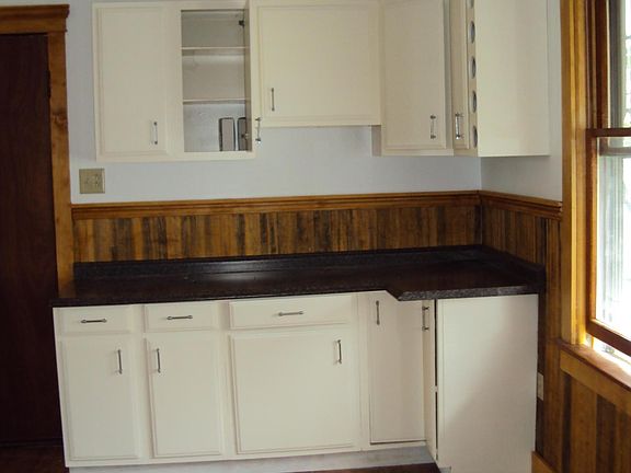 kitchen view with south facing window and chandelier
(white stove has been replaced, the new one is stainless)