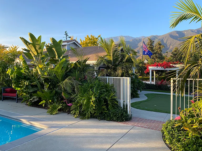 Your private backyard oasis awaits_featuring a sparkling pool, fun putting green, and a bocce court for endless outdoor entertainment.