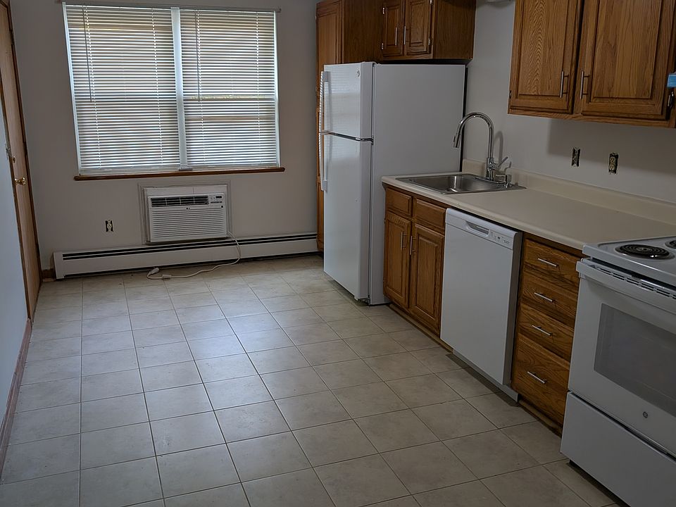 Kitchen with new appliances and air conditioner.