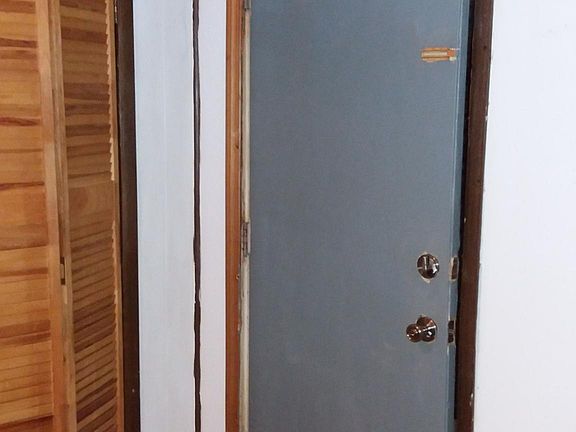 Entrance door inside next to coat closet. (Painted, new ceiling tiles)