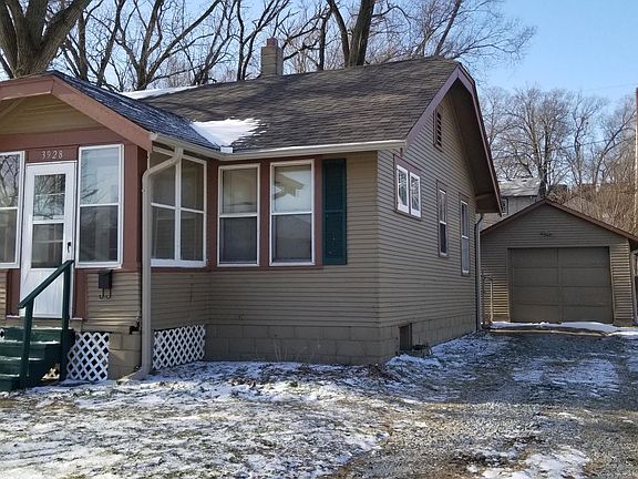 Front of home with detached garage.
