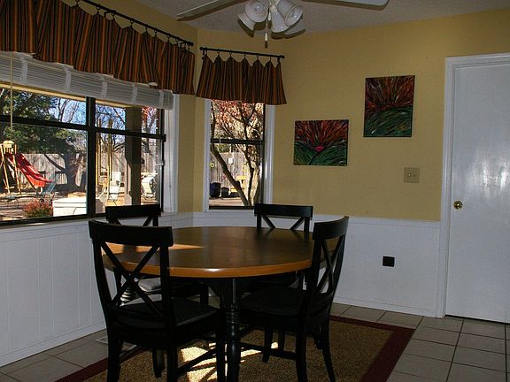 breakfast nook overlooks covered patio, large deck and pool