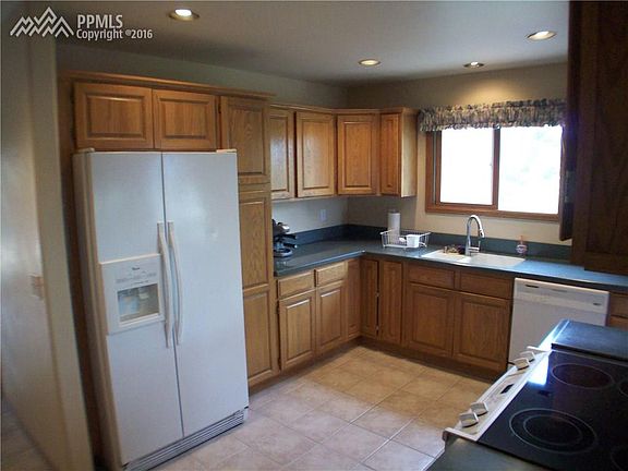 This gourmet kitchen features; side-by-side refrigerator with ice and water thro
