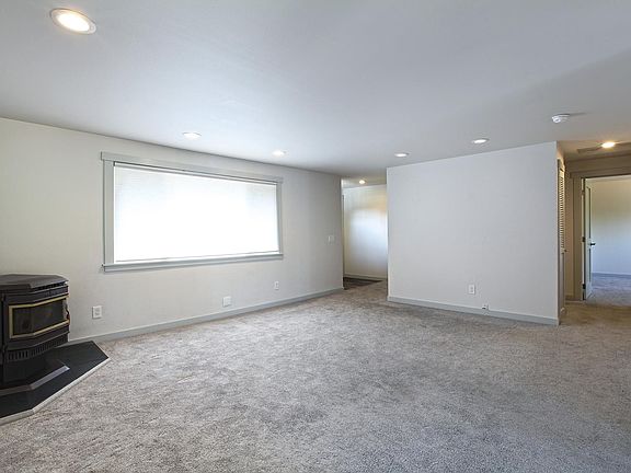 Living room shows hallway to additional bedrooms and bathroom