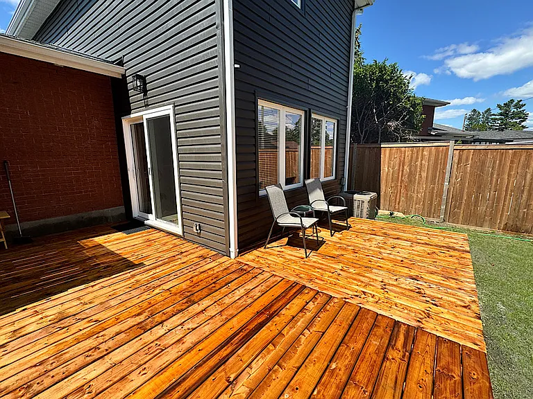 Private wooden deck, ideal for relaxing outdoors during your stay at our Ottawa furnished rental.