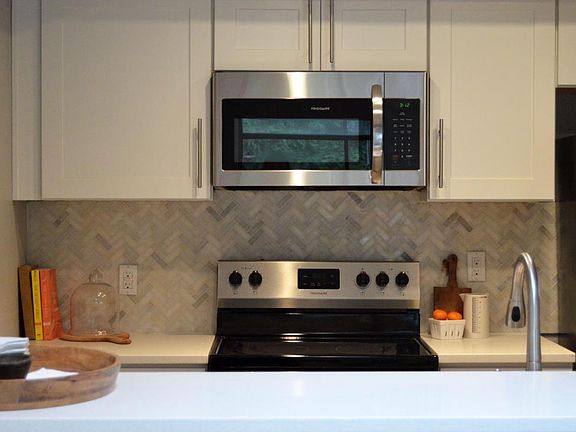 Kitchen with herringbone marble backsplash