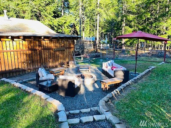 Packwood living at its finest! Lots of room for social distance gathering! Fire pit area that offers lots of room to the sides for some good ole' corn hole or whatever game your family enjoys! Extra space included on property beyond the fencing in back.