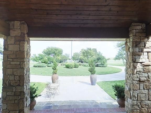 Grand entrance: Circular drive, gorgeous cedar lined porch, stone and slate tile