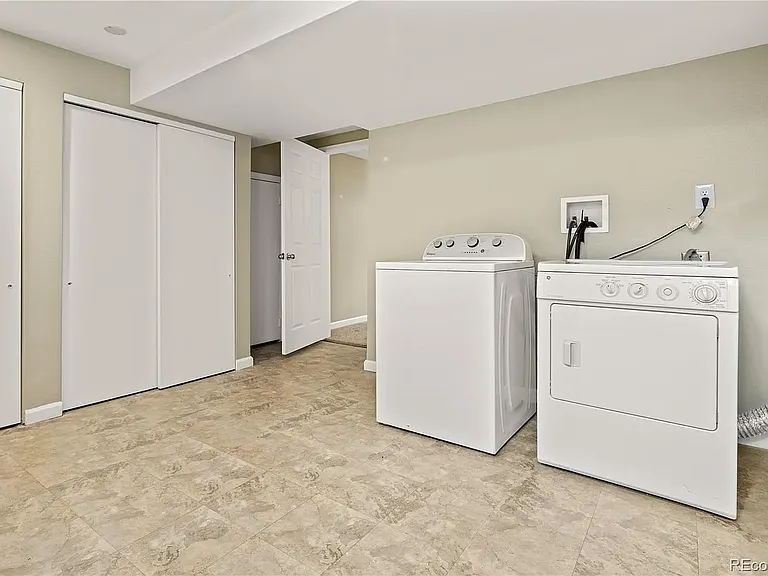 Downstairs utility room / office space with full washer and dryer.