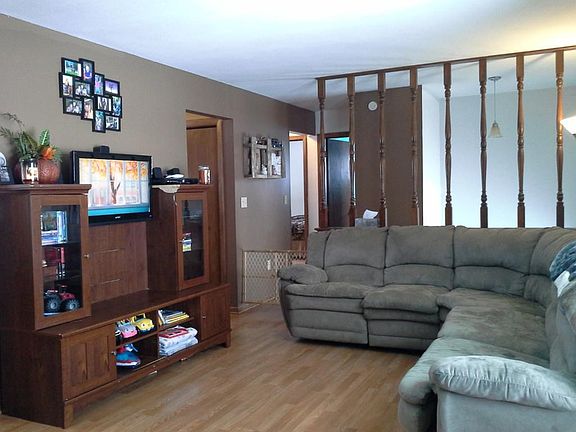 Main floor living room opens up to kitchen and dining.