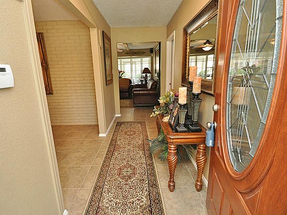 Wow your guests the moment they walk in the door! New fiberglass leaded front door, tile, paint and light fixture. Security system included!