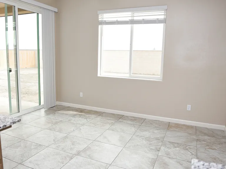 eat in kitchen area, doors to the backyard.