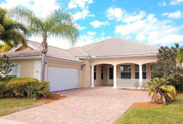Front of home. Big front porch and 2 car garage