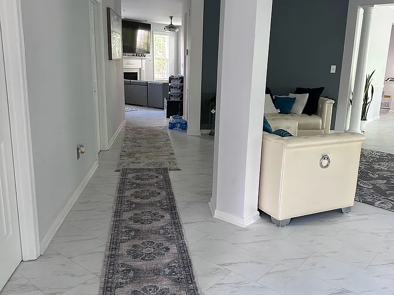 Hallway from main door leading to kitchen and living room spaces