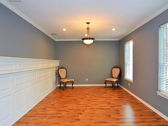 Formal Living or Study with Updated Wainscot Molding with Ledge.  Fresh new Designer Paint and Wood Laminate Flooring.