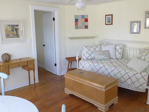 Living room with fan. The is additonal book shelving to the right, out of picture.