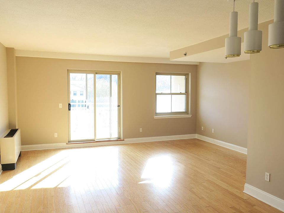 Living room and dining area with sliding door to south-facing balcony