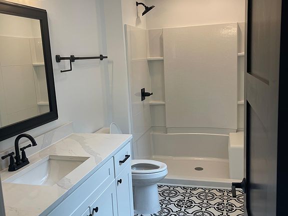 Off of the master bedroom is the spacious bathroom with lots of storage space.
