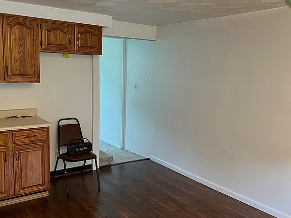 New stainless steel refrigerator has been added (where the chair sits). Doorway opening to stairs on left and LR - straight).