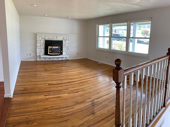 Living room on main level with 10_ windows, fireplace, refinished hardwood floor