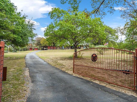 Gated entrance leads up the hill to the farmhouse