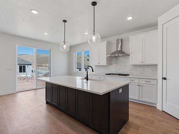 The kitchen has sprawling quartz countertops.