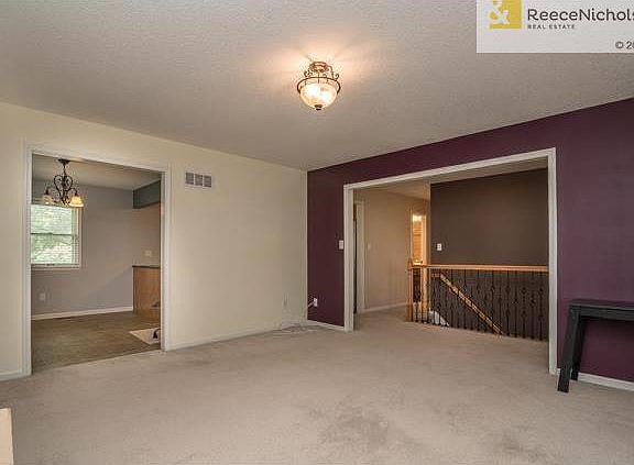 Living room with fireplace flows to eat-in kitchen
