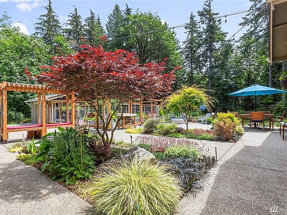 The front yard patio has many seating areas, raised gardens, and...