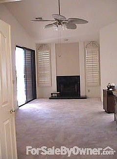 Master bedroom.
						:
						View of Master bedroom with fireplace & patio door to pool from hallway.