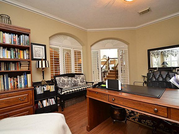 Large study has hand scraped hardwood floors.