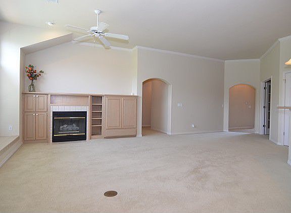 Living room has fireplace and built ins